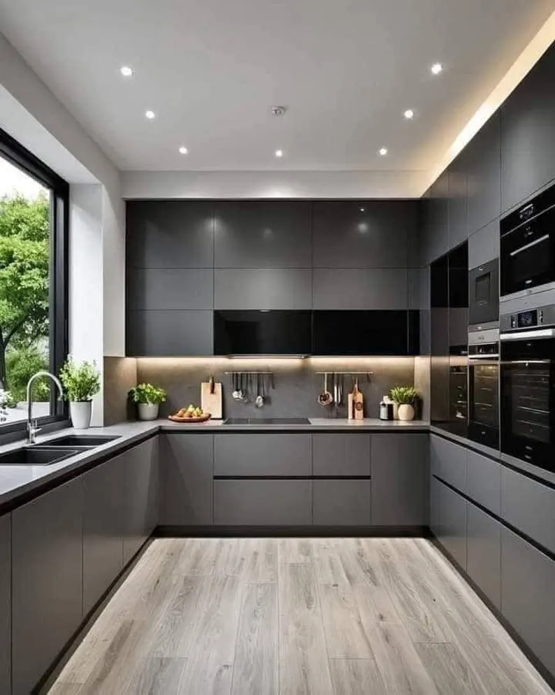 A modern grey handleless kitchen with integrated appliances